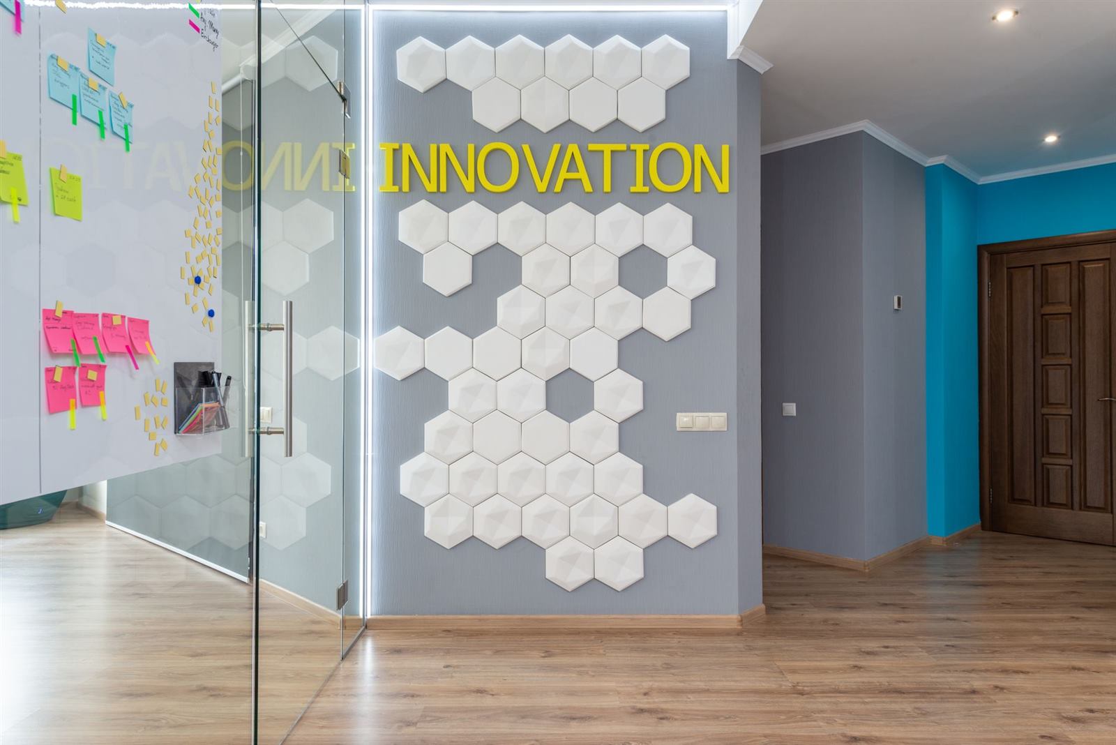 Geometric decoration on wall with Innovation inscription near glass door of conference roo